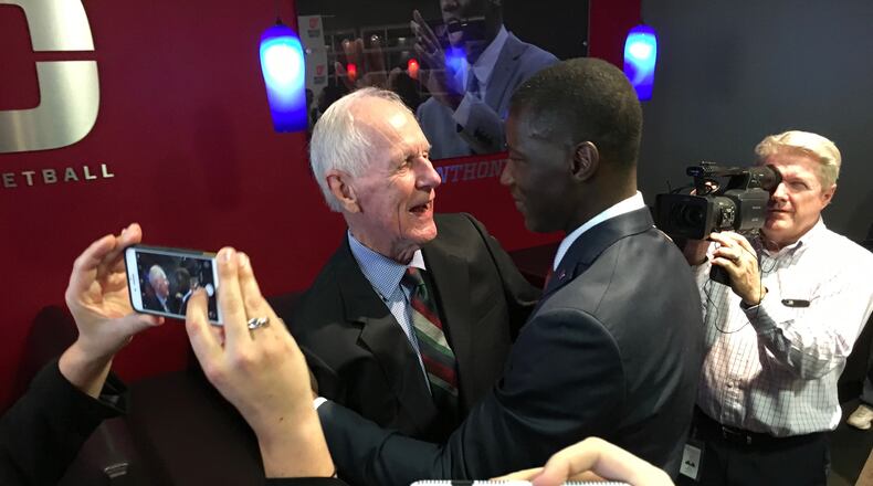 Don Donoher and Anthony Grant hug after his introductory press conference Saturday at UD Arena. David Jablonski/Staff