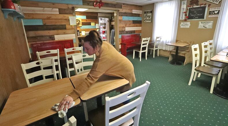 Brittany Lachey cleans a table in the dinning room of the Stagecoach Cafe in New Carlisle Thursday. When it comes to small businesses in Clark County, it doesn't come much smaller than the Stagecoach with a seating capacity less than 20 people. BILL LACKEY/STAFF