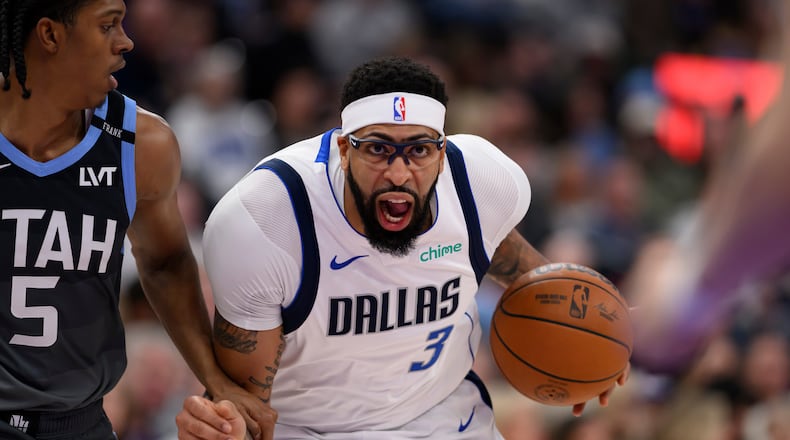 Dallas Mavericks forward Anthony Davis (3) drives to the basket while guarded by Utah Jazz forward Cody Williams (5) during the first half of an NBA basketball game, Thursday, Jan. 8, 2026, in Salt Lake City. (AP Photo/Tyler Tate)