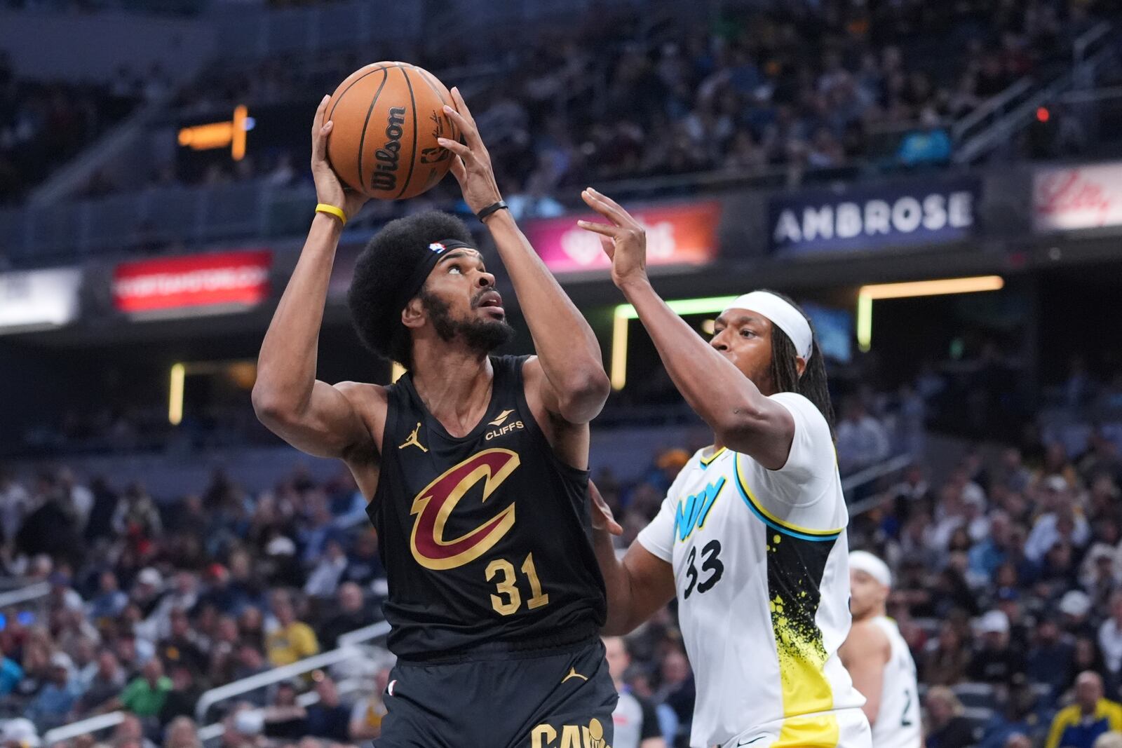 Cleveland Cavaliers center Jarrett Allen (31) shoots over Indiana Pacers center Myles Turner (33) during the first half of an NBA basketball game in Indianapolis, Thursday, April 10, 2025. (AP Photo/Michael Conroy)