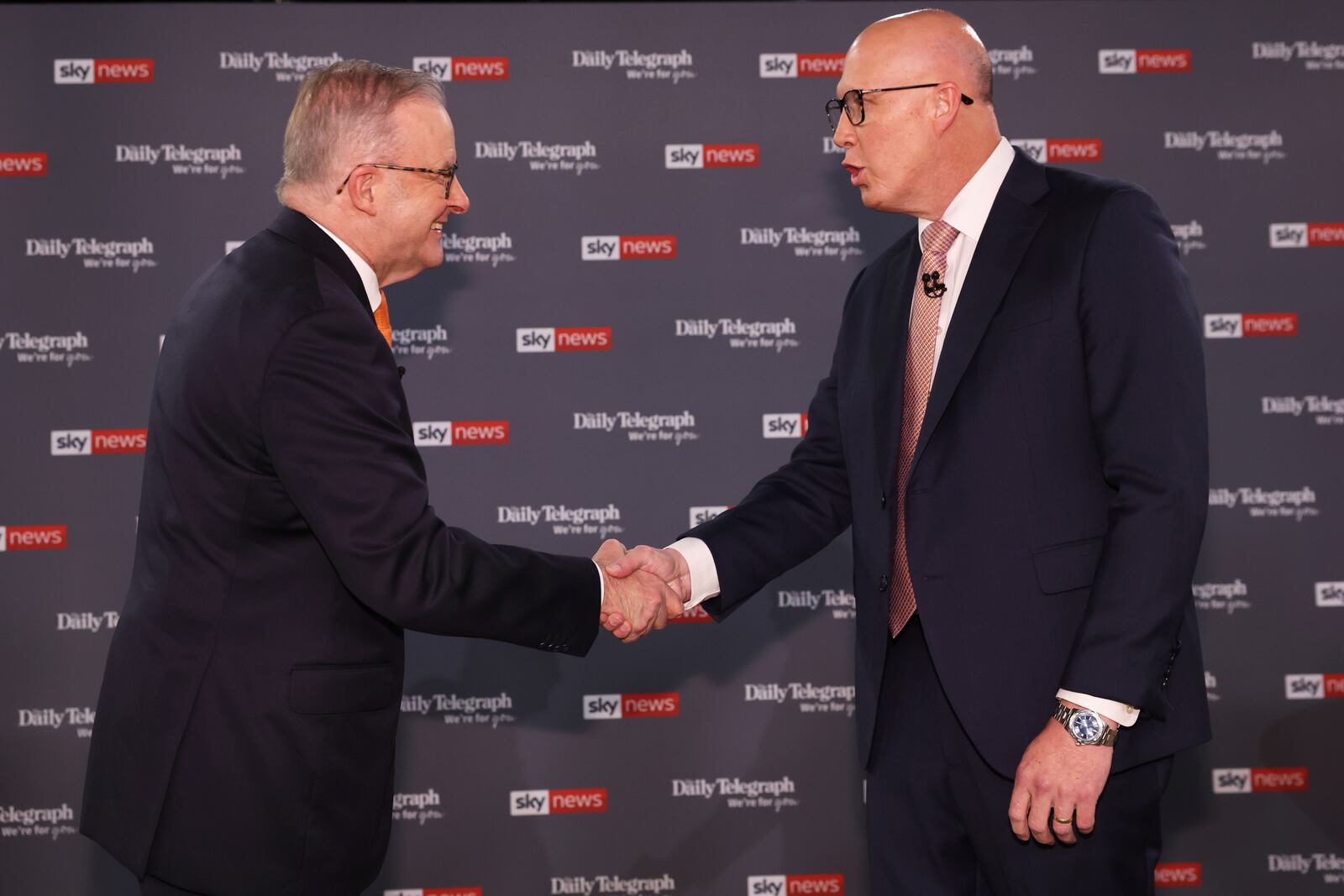 Australian Prime Minister Anthony Albanese, left, shakes hands with Opposition leader Peter Dutton ahead of their TV debate in Sydney, Australia, Tuesday, April 8, 2025. (Jason Edwards /Pool Photo via AP)