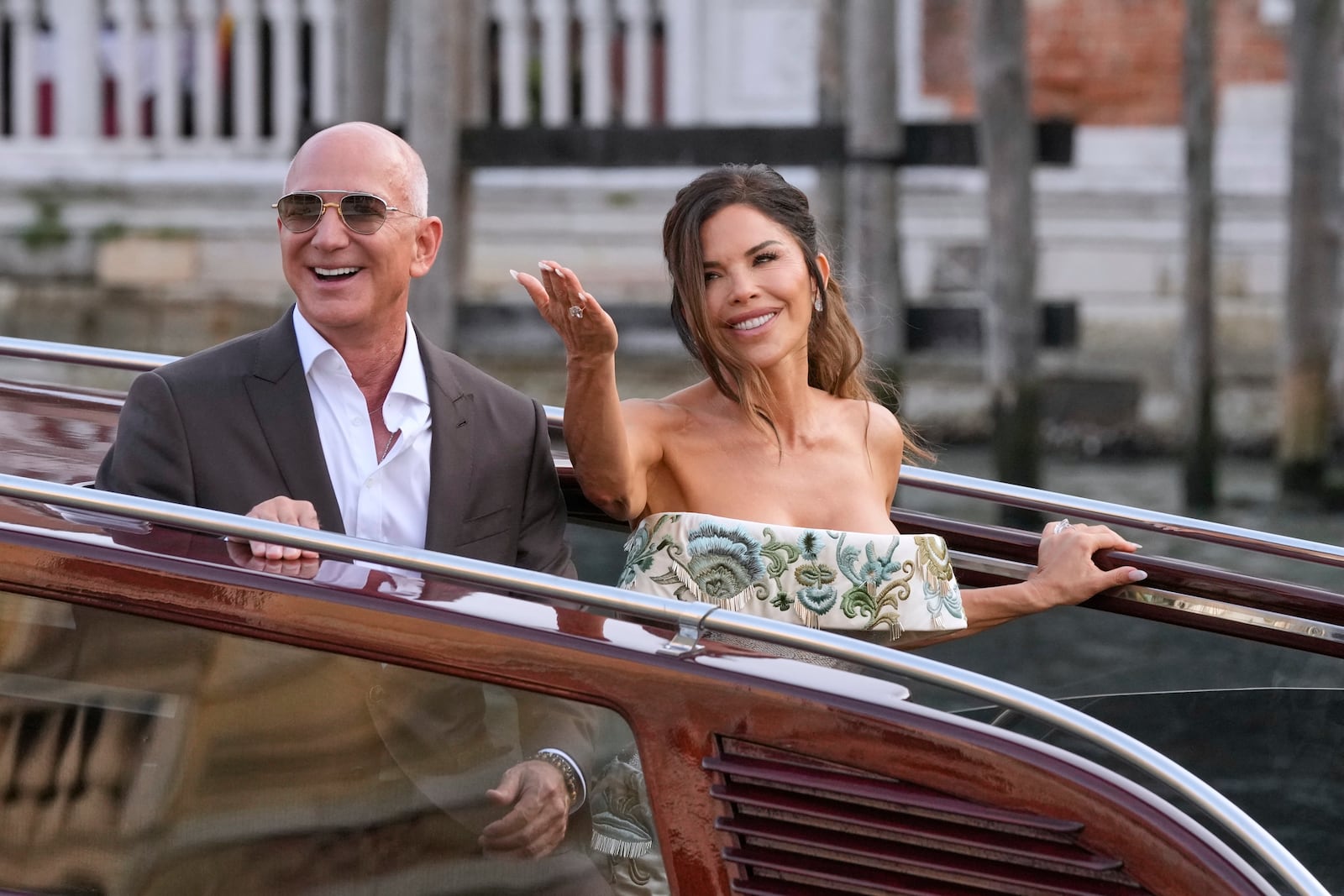 Jeff Bezos, left, and Lauren Sanchez kiss as they leave a hotel for their pre wedding reception, in Venice, Italy, Thursday, June 26, 2025. (AP Photo/Luca Bruno)