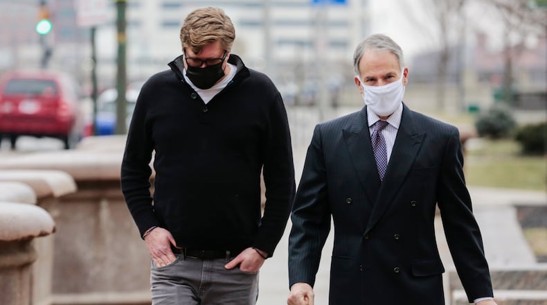 Dustin Thompson, left, of Columbus, who is accused of being part of the Jan. 6 insurrection at the U.S. Capitol, arrives with his lawyer, Sam Shamansky, to turn himself in on Monday, Jan. 25, 2021, at the Joseph P. Kinneary U.S. District Courthouse in Columbus, Ohio. (Joshua A. Bickel/The Columbus Dispatch via AP)