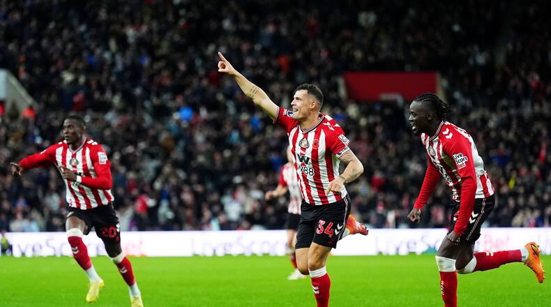 Sunderland's Granit Xhaka, center, celebrates scoring during the English Premier League soccer match between Sunderland and Everton in Sunderland, England, Monday Nov. 3, 2025. (Owen Humphreys/PA via AP)