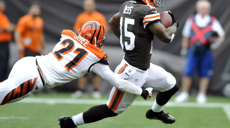Cleveland Browns wide receiver Davone Bess (15) is tackled by Cincinnati Bengals defensive back Brandon Ghee (21) after a catch in the first quarter of an NFL football game Sunday, Sept. 29, 2013, in Cleveland. (AP Photo/David Richard)