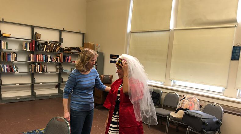 Director Kathleen Day, left, helps make a costume adjustment at a recent rehearsal for Springfield Civic Theatre's upcoming comedy "Dearly Beloved", the group's first comedy in nearly three years./Contributed