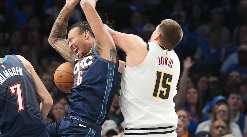 Oklahoma City Thunder forward Jaylin Williams (6) falls into Denver Nuggets center Nikola Jokic (15) as he goes after a rebound during the second half of an NBA basketball game, Friday, Feb. 27, 2026, in Oklahoma City. (AP Photo/Kyle Phillips)