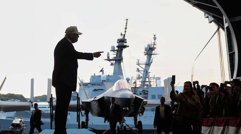 President Donald Trump gestures as he walks towards the stage before speaking to members of the military aboard the USS George Washington, an aircraft carrier docked at an American naval base, in Yokosuka, Tuesday, Oct. 28, 2025. (AP Photo/Mark Schiefelbein)