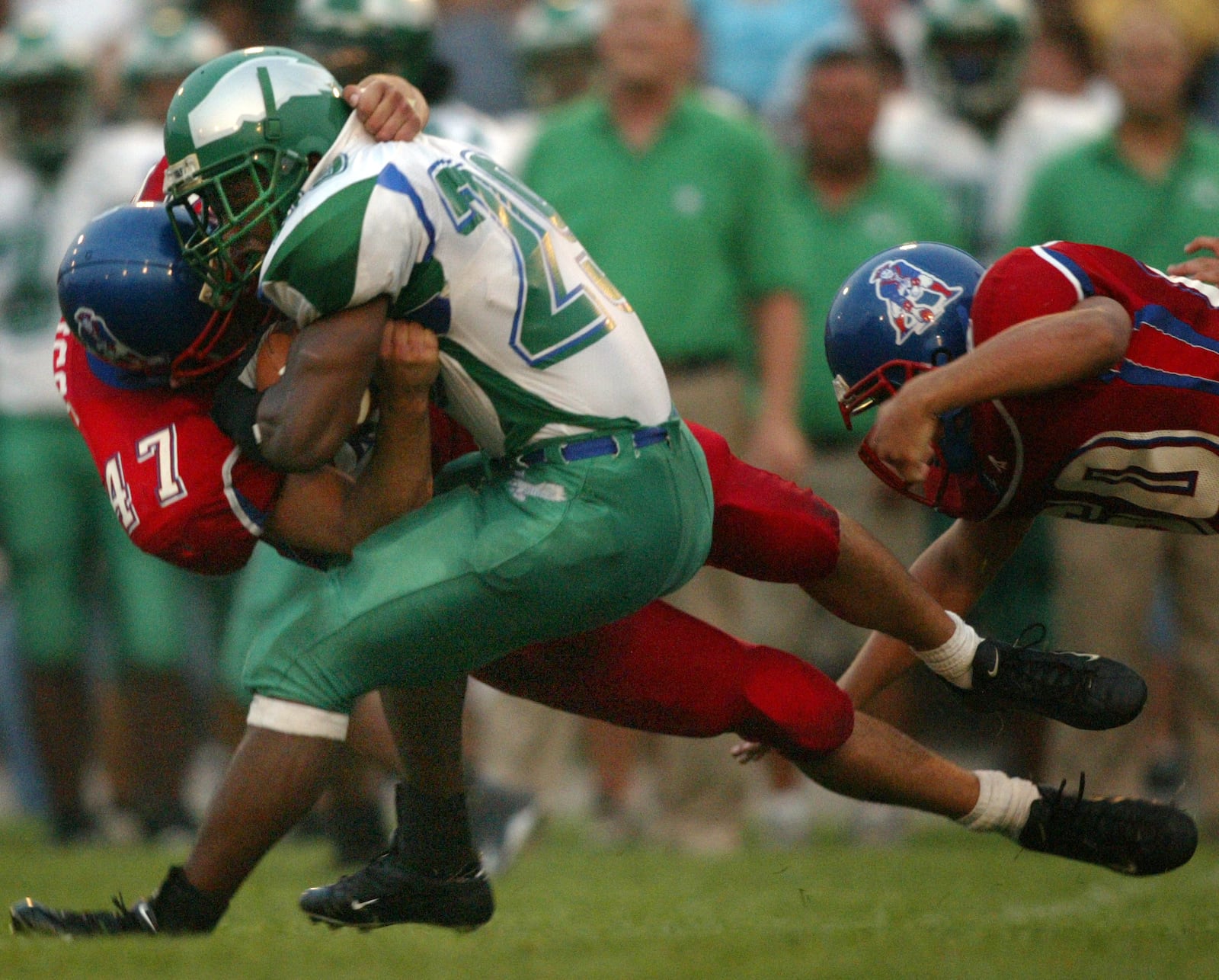 Jason Riggs (47), a Carroll linebacker, makes a solo tackled on Javon Ringer, the elusive running back of Chaminade-Julienne, during their game in 2005.
