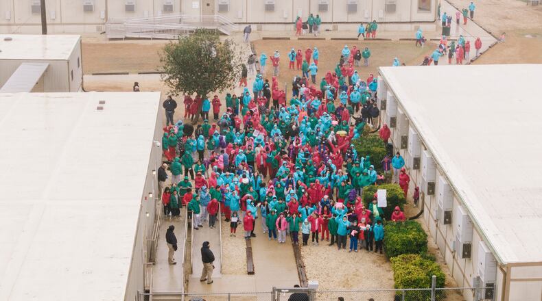 FILE - Detainees held at the South Texas Family Residential Center wave signs during a demonstration in Dilley, Texas, Saturday, Jan. 24, 2026. (AP Photo/Brenda Bazán, File)