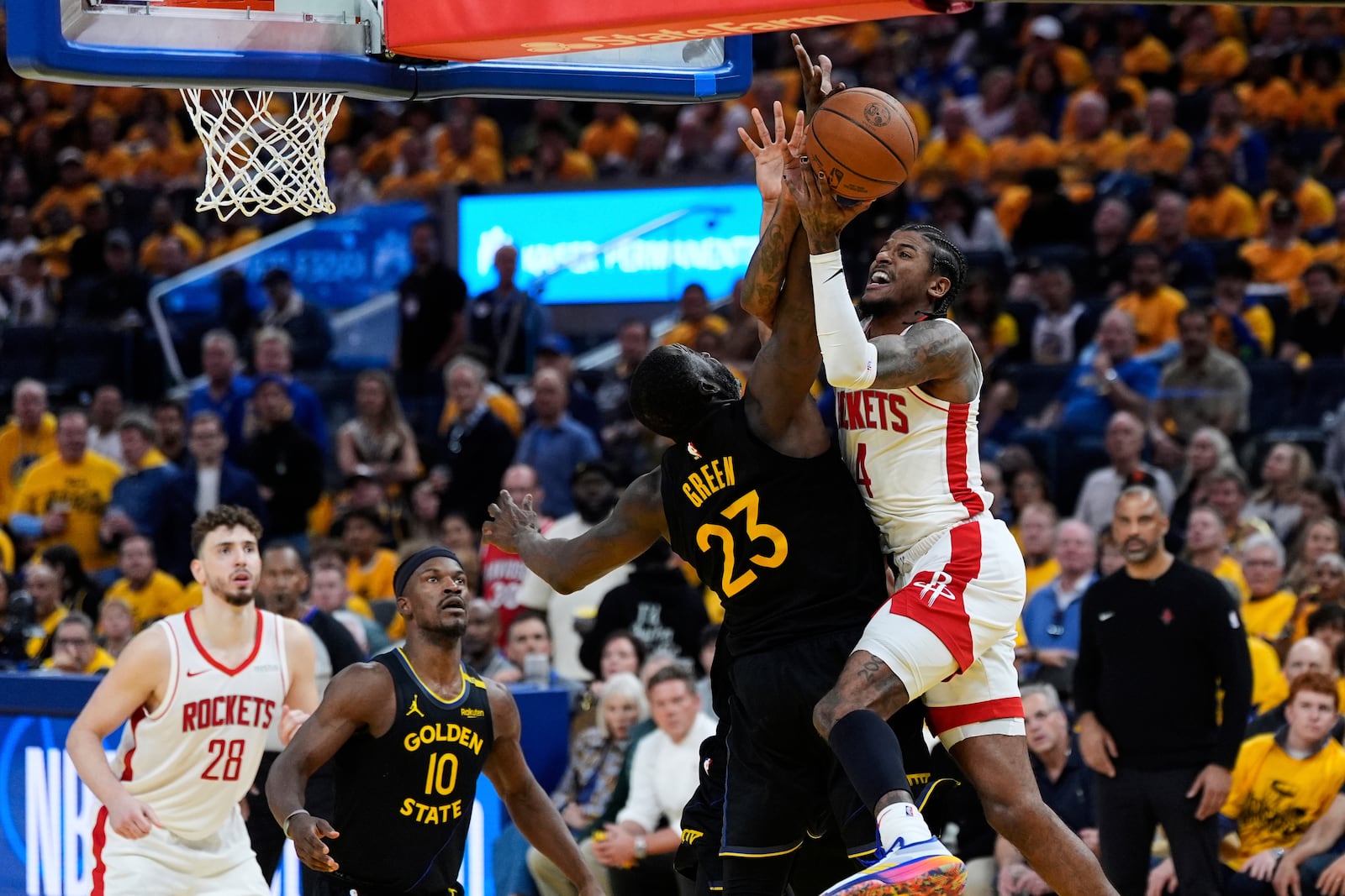 Houston Rockets guard Jalen Green (4) shoots while defended by Golden State Warriors forward Draymond Green (23) during the second half of Game 6 of an NBA basketball first-round playoff series Friday, May 2, 2025, in San Francisco. (AP Photo/Godofredo A. Vásquez)