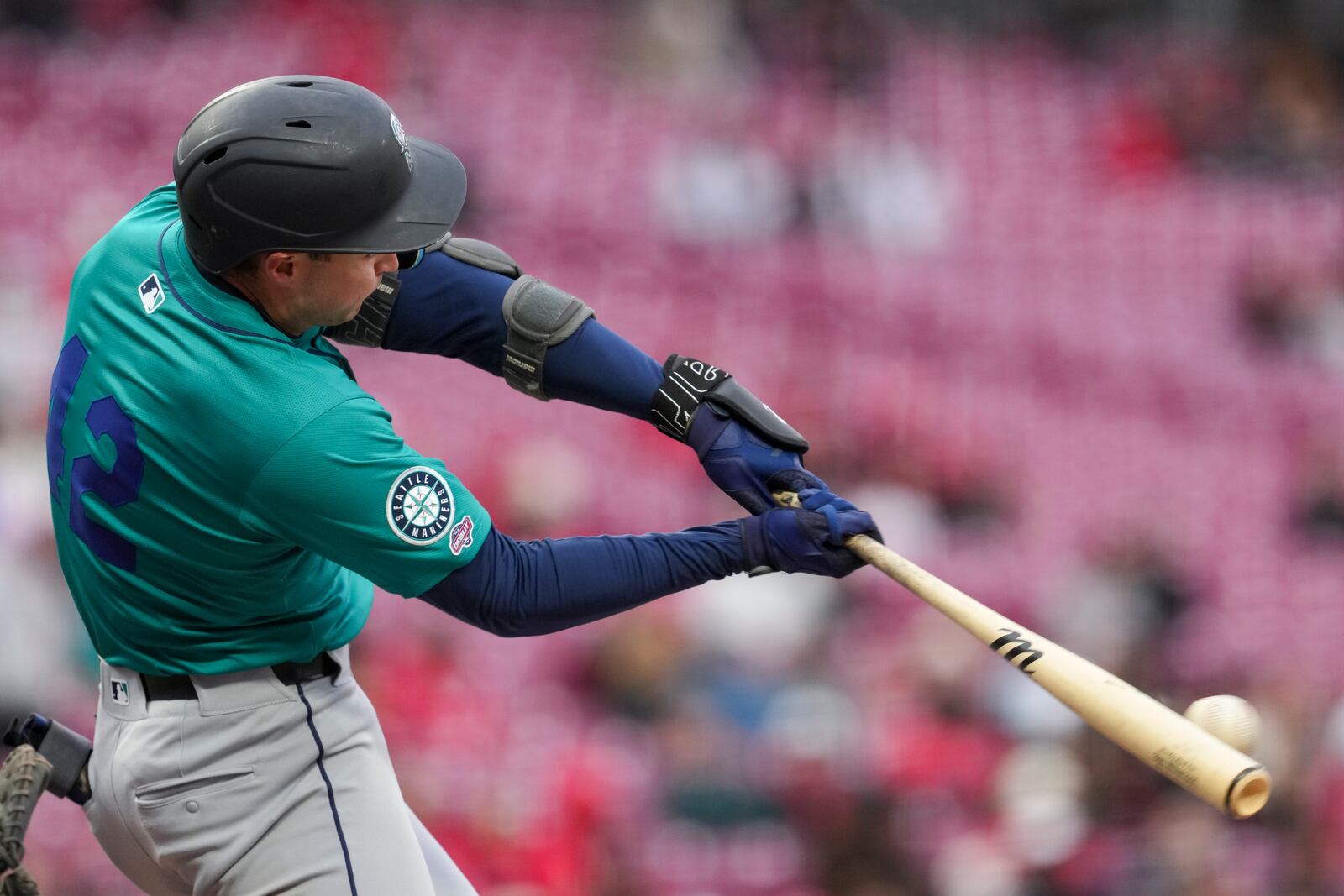 Seattle Mariners' Ben Williamson hits a single during his major league debut in the second inning of a baseball game against the Cincinnati Reds, Tuesday, April 15, 2025, in Cincinnati. All the players are wearing 42 in honor of Jackie Robinson Day. (AP Photo/Jeff Dean)