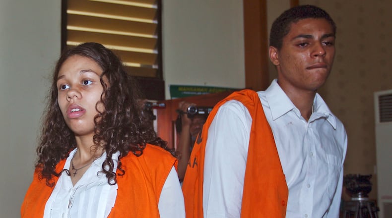 FILE - In this March 12, 2015 file photo, Heather Mack, left, and her boyfriend Tommy Schaefer, both from Chicago, Ill., who are accused of of murdering Mack's mother Sheila von Wiese-Mack whose body was later found in a suitcase, enter the court room prior to the start of their trial hearing at the district court in Denpasar, Bali, Indonesia. (AP Photo/Firdia Lisnawati, File)