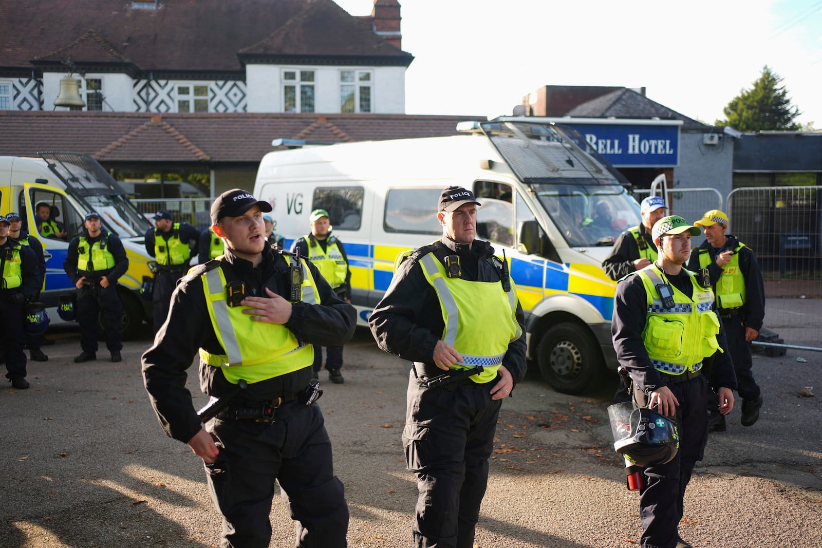 Police gather outside the Bell Hotel in the town of Epping, Essex, England, during a protest against asylum seekers, northeast of London, Sunday, July 20, 2025. (Yui Mok/PA via AP)
