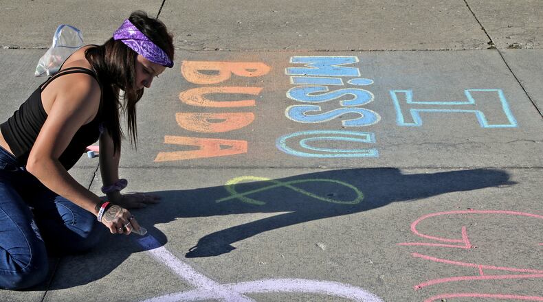 Dejia Hughes draws a picture and message to her friends on the Springfield City Hall Plaza Wednesday, August 31, 2022 during the first ever Chalk the Walk to celebrate the memory of those lost to substance overdose and help prevent future overdoses. Chalk the Walk coincided with International Overdose Awareness Day. The event, presented by the Clark County Substance Abuse Coalition in collaboration with Clark County Partners in Prevention, also featured overdose prevention resources including free Narcan kits. BILL LACKEY/STAFF