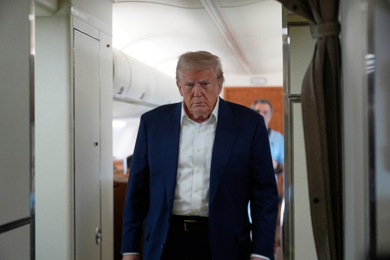 President Donald Trump walks to talk with reporters on Air Force One as he heads back to Washington, Sunday, May 4, 2025, from West Palm Beach, Fla. (AP Photo/Manuel Balce Ceneta)
