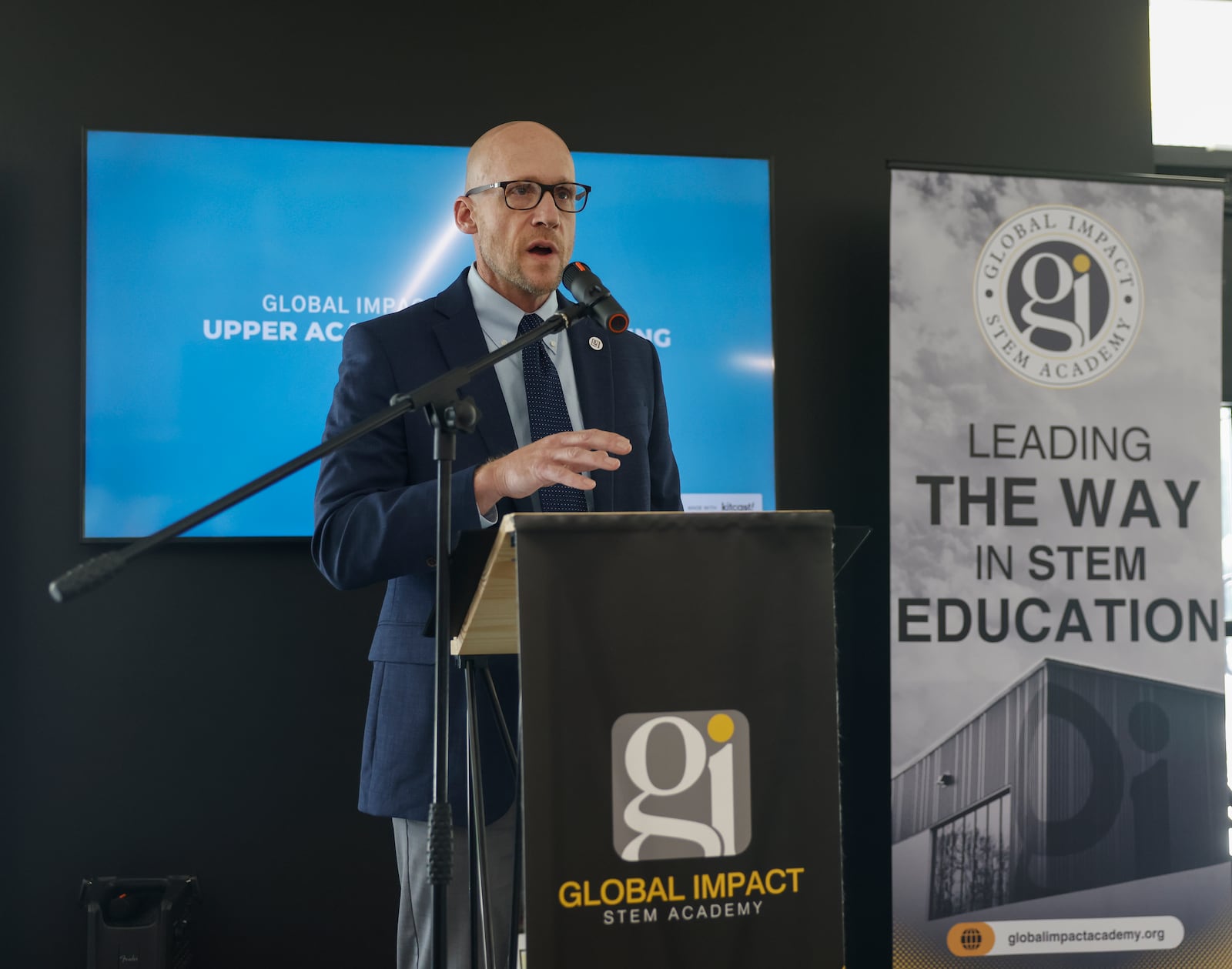 Josh Jennings, founding director of Global Impact STEM Academy, speaks during a ribbon cutting ceremony to celebrate the new upper academy of the Global Impact STEM Academy on Friday, May  23, 2025, at Clark State College. JOSEPH COOKE/STAFF