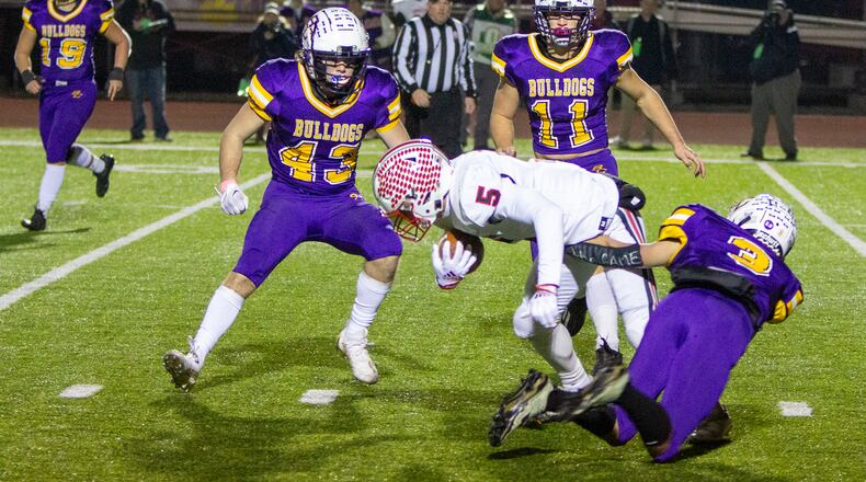 Tippecanoe's Evan Liette is tackled after a catch during the first half of Friday's Division III state semifinal against Bloom-Carroll at London High School. CONTRIBUTED/Jeff Gilbert