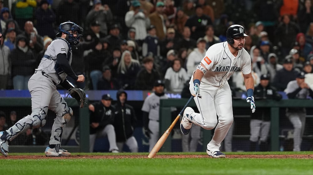Seattle Mariners' Cal Raleigh hits a game-winning single during the ninth inning of a baseball game against the New York Yankees, Monday, March 30, 2026, in Seattle. (AP Photo/Lindsey Wasson)