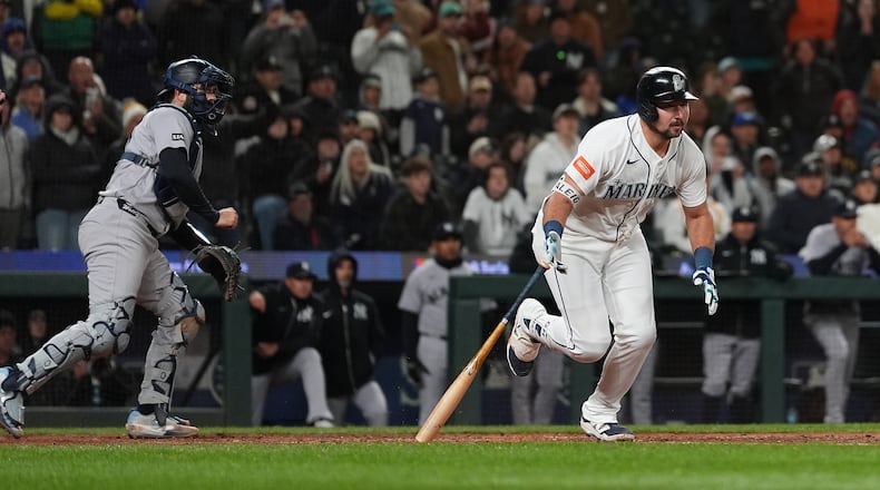 Seattle Mariners' Cal Raleigh hits a game-winning single during the ninth inning of a baseball game against the New York Yankees, Monday, March 30, 2026, in Seattle. (AP Photo/Lindsey Wasson)