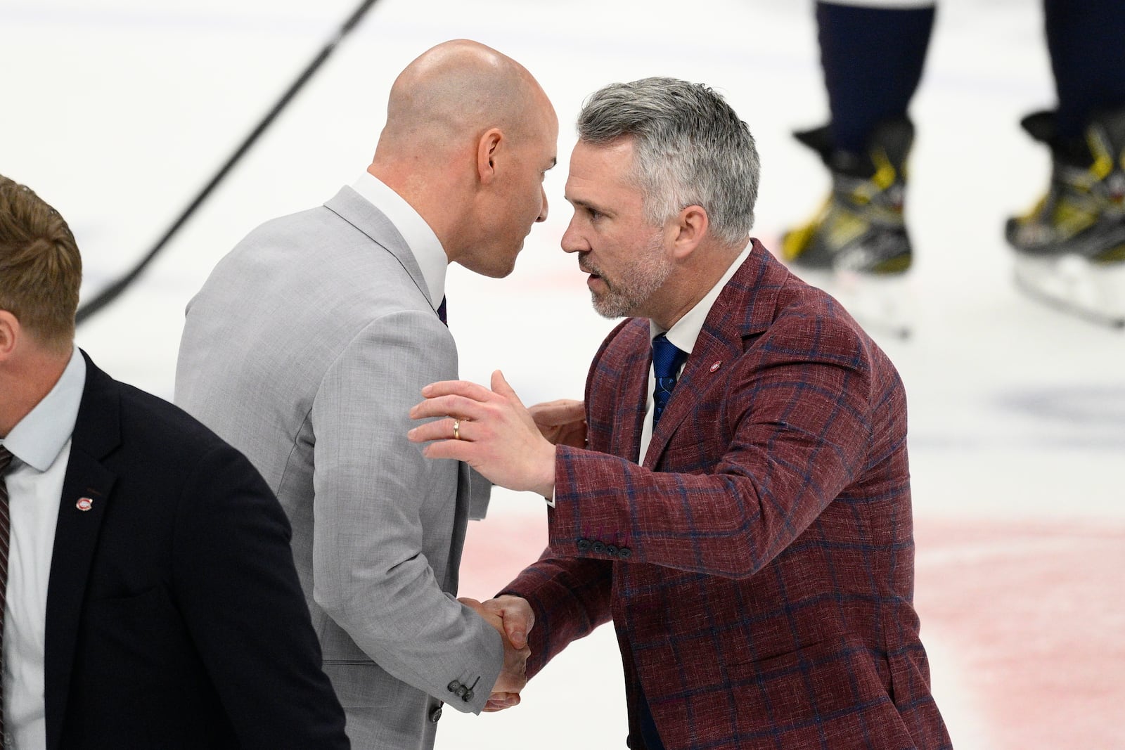 Washington Capitals head coach Spencer Carbery, left, shakes hands with Montreal Canadiens head coach Martin St. Louis, right, after Game 5 of a first-round NHL hockey playoff series Wednesday, April 30, 2025, in Washington. (AP Photo/Nick Wass)