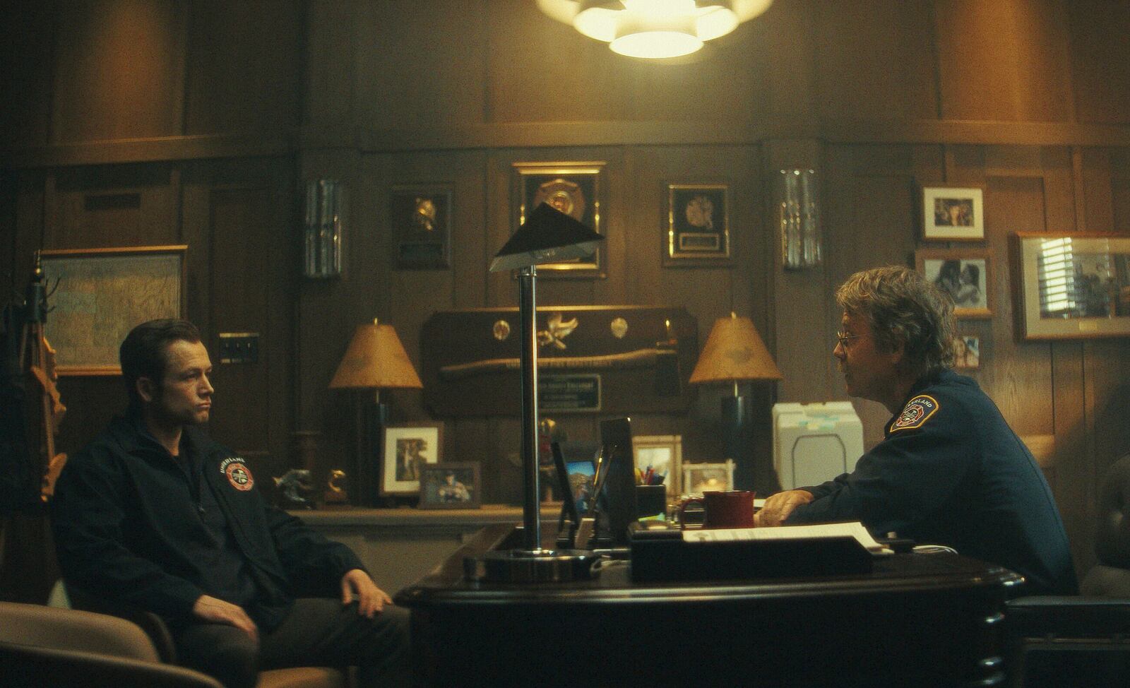 This image released by Apple TV+ shows Taron Egerton, left, and Greg Kinnear in a scene from "Smoke." (Apple TV+ via AP)