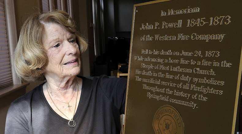 Mary Nave holds a plaque that will be presented during the re-dedication of the First Lutheran Church steeple on June 23. The plaque honors firefighters, including John Powell, who was killed while fighting a fire at the church in 1873. Bill Lackey/Staff