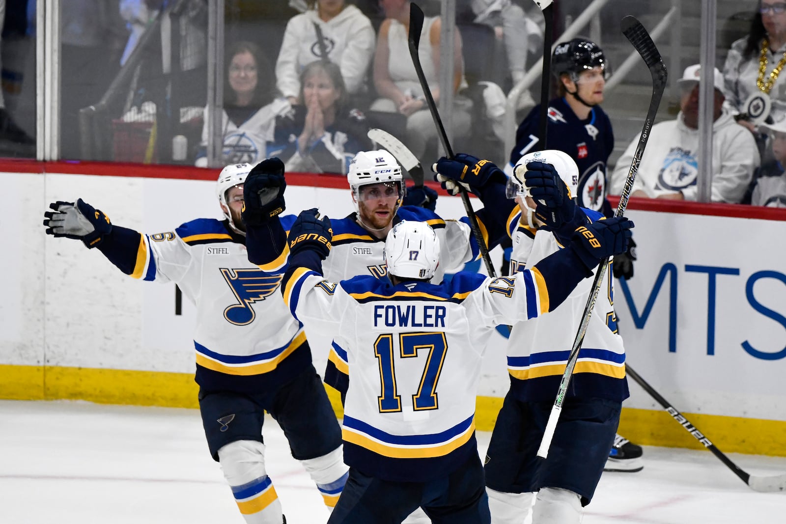 St. Louis Blues' Radek Faksa (12) celebrates after his goal against the Winnipeg Jets with Cam Fowler (17) during the second period of Game 7 in an NHL hockey first-round playoff series in Winnipeg, Manitoba, Sunday, May 4, 2025. (Fred Greenslade/The Canadian Press via AP)
