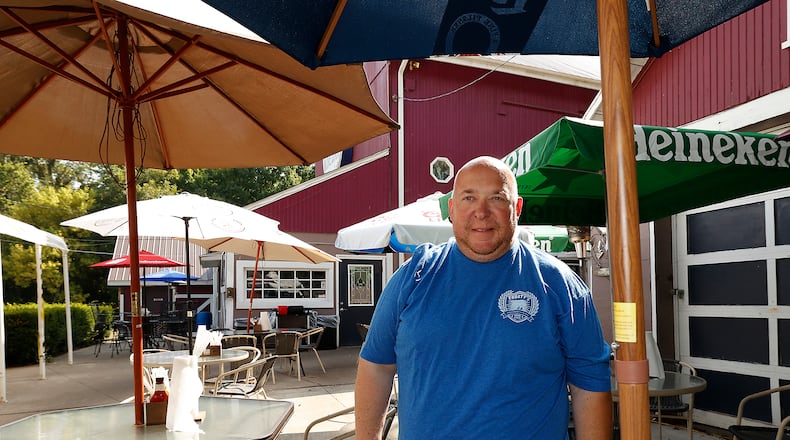 Kris Frost, owner of Frosty's Good Food and Fine Spirits on Upper Valley Pike, on the patio before business opens Monday, August 26, 2024. BILL LACKEY/STAFF