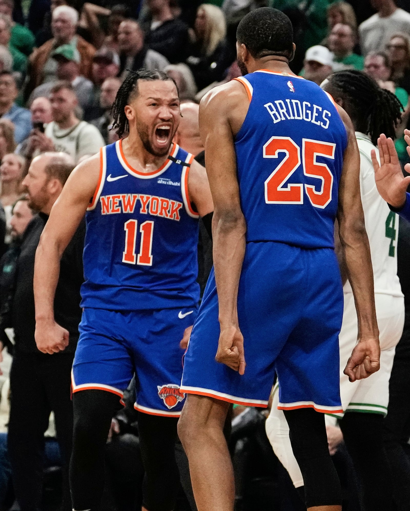 New York Knicks guard Jalen Brunson (11) celebrates with Mikal Bridges (25) after defeating the Boston Celtics in Game 1 of an NBA basketball second-round playoff series Monday, May 5, 2025, in Boston. (AP Photo/Charles Krupa)