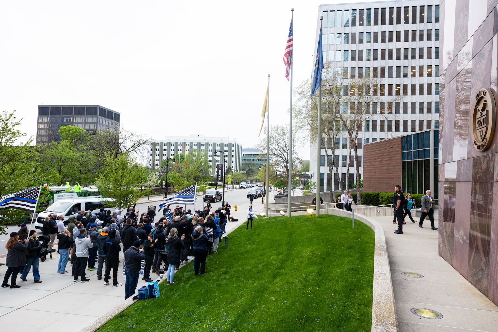 Family members of former Grand Rapids Police officer Christopher Schurr enter the Kent County Courthouse as supporters gather outside in Grand Rapids, Mich. on Friday, May 2, 2025. (Joel Bissell /Kalamazoo Gazette via AP)