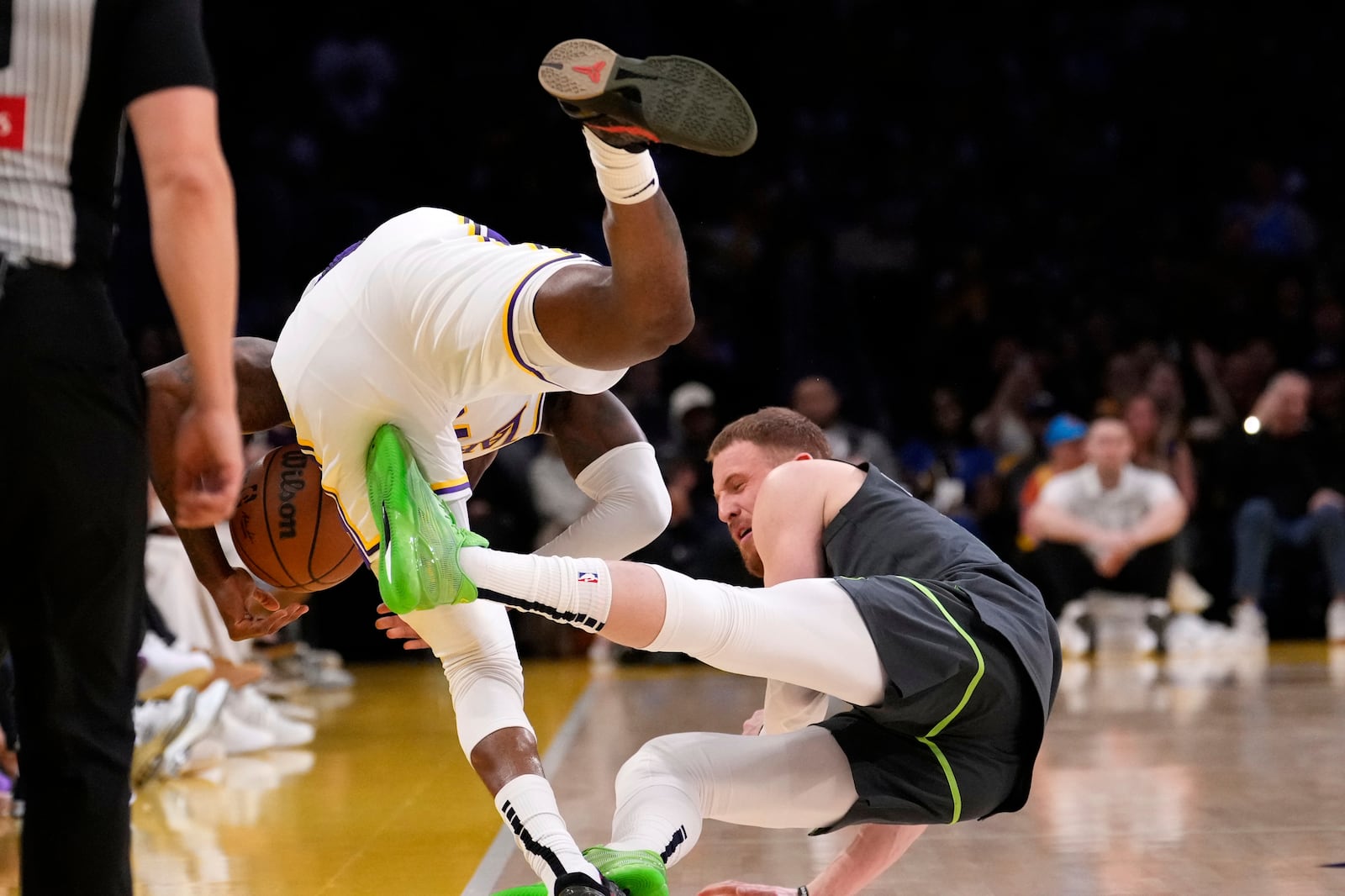 Los Angeles Lakers forward Jarred Vanderbilt, left, and Minnesota Timberwolves guard Donte DiVincenzo collide during the second half in Game 1 of an NBA first-round playoff series Saturday, April 19, 2025, in Los Angeles. (AP Photo/Mark J. Terrill)