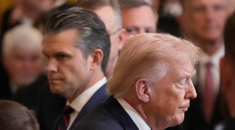 President Donald Trump walks past Defense Secretary Pete Hegseth as he exist the East Room of the White House following the Medal of Honor ceremony, Monday, March 2, 2026, in Washington. (AP Photo/Mark Schiefelbein)