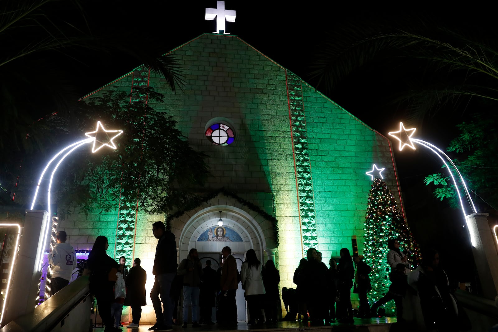 FILE - Palestinian Christians wait to pray at the midnight Christmas Eve mass out side the Deir Al Latin Holy Family Catholic Church in Gaza City, Dec. 24, 2021. (AP Photo/Adel Hana, file)