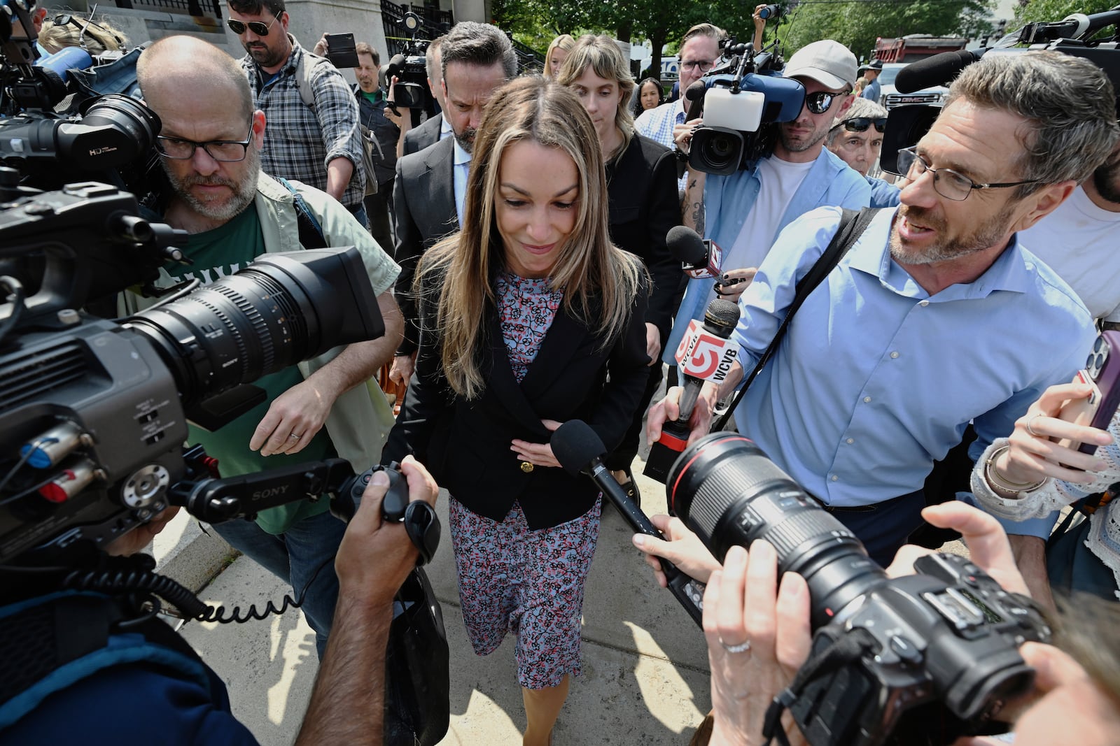 Karen Read, is surrounded by reporters as she and her legal team leave the Dedham, Mass. courthouse, after the judge issued instructions to the jury in Read's trial at Norfolk Superior Court, Friday, June 13, 2025, in Dedham, Mass. (AP Photo/Josh Reynolds)
