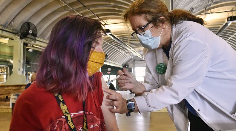 Lynn Hanck, right, from Mercy Health, gives a vaccine to Kayla Bittner. Mercy Health-Fairfield Hospital offered first-dose vaccinations at Jungle Jim's Oscar Event Center in Fairfield Tuesday, April 6, 2021, and will offer them from 9 a.m. to 2 p.m. Wednesday, April 7, 2021. It's estimated 1,200 people, 600 on Tuesday and 600 on Wednesday, will receive the first-shot of the novel coronavirus vaccine. NICK GRAHAM / STAFF