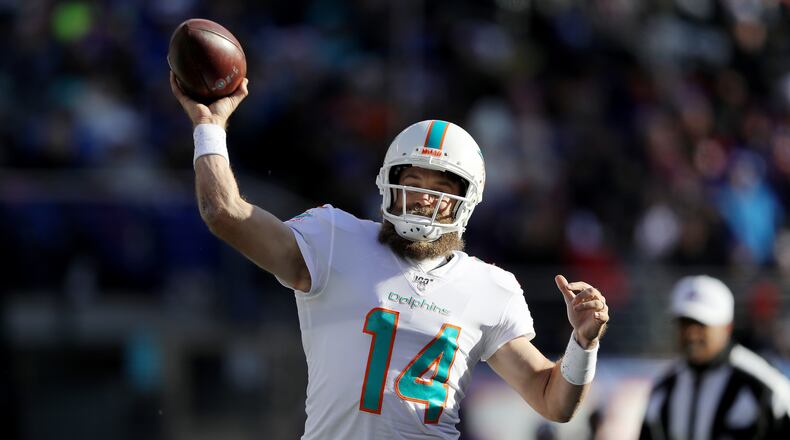 EAST RUTHERFORD, NEW JERSEY - DECEMBER 15: Ryan Fitzpatrick #14 of the Miami Dolphins passes the ball in the first quarter against the New York Giants at MetLife Stadium on December 15, 2019 in East Rutherford, New Jersey. (Photo by Elsa/Getty Images)