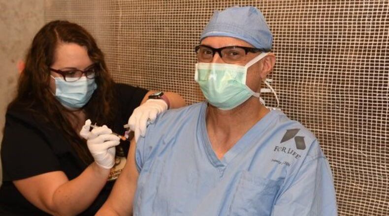 Kettering Health Network surgeon Dr. Brian Ondulick received his first dose of the Moderna vaccine Monday at Soin Medical Center in Beavercreek.