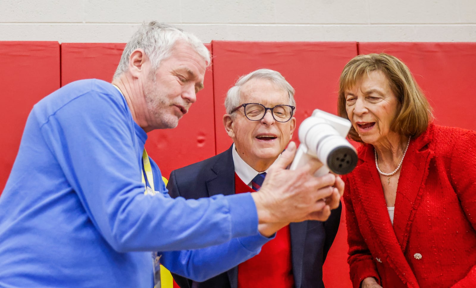 Don Engel, left, opticial technician for Health Partners of Western Ohio, shows Ohio Gov. Mike DeWine, center, and First Lady Fran DeWine technology he uses to examine student's eyes as part of a new children's eyesight program, OhioSEE, on Monday, Feb. 9, 2026, in South Vienna. JOSEPH COOKE/STAFF