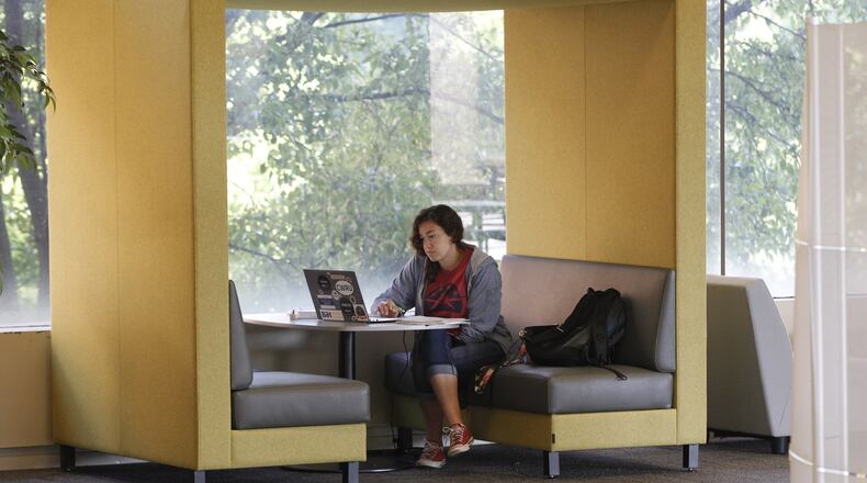 Gloria Campos, 19, utilizes new furniture in the Paul Laurence Dunbar Library at Wright State University to study physics. The library recently completed a renovation that included new furniture and carpet to replace the 30-year-old furnishings which were recycled throughout the university. TY GREENLEES / STAFF