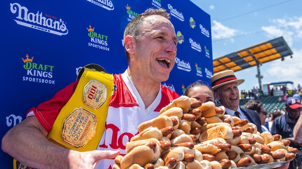 FILE - Joey Chestnut, winner of the 2021 Nathan's Famous Fourth of July International Hot Dog-Eating Contest, poses for photos in Coney Island's Maimonides Park, July 4, 2021, in the Brooklyn borough of New York. (AP Photo/Brittainy Newman, File)
