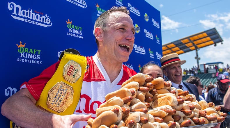 FILE - Joey Chestnut, winner of the 2021 Nathan's Famous Fourth of July International Hot Dog-Eating Contest, poses for photos in Coney Island's Maimonides Park, July 4, 2021, in the Brooklyn borough of New York. (AP Photo/Brittainy Newman, File)