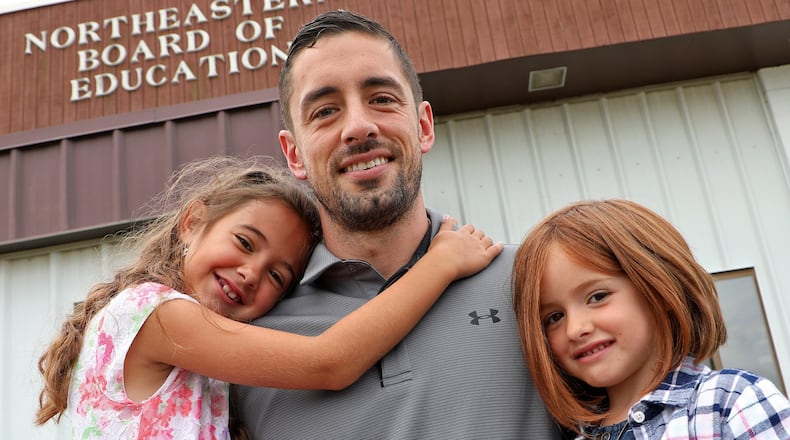 Drew Snyder and his daughter, Tilly, left, and Vada, are excited about his roll as the new principal of Rolling Hills Elementary in the Northeastern School district. BILL LACKEY/STAFF