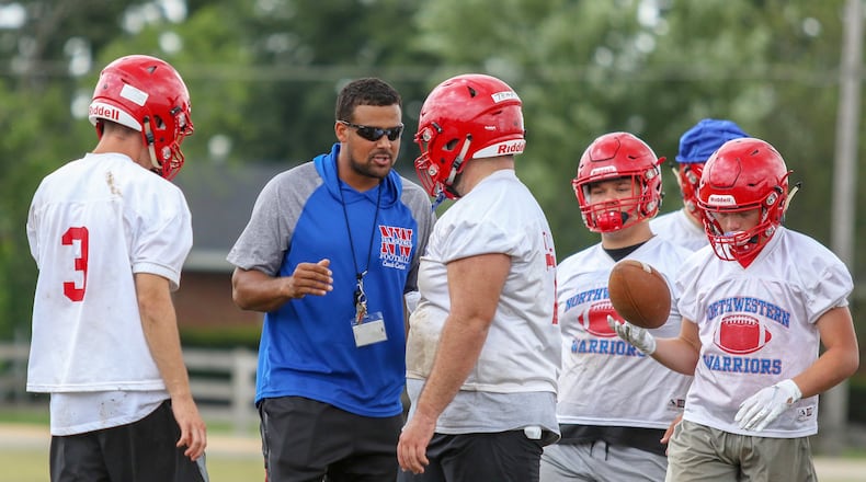Northwestern High School football coach Shane Carter talks to his offensive line during a practice on Thursday in Springfield. Fall sports practice began across Ohio on Thursday. CONTRIBUTED PHOTO