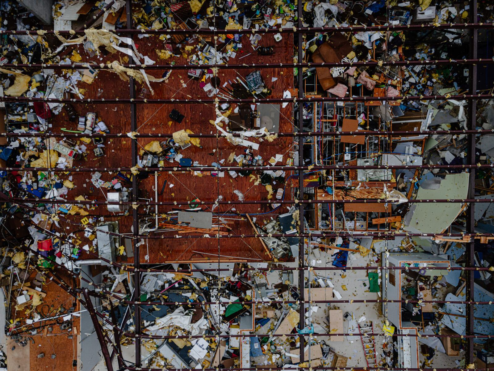In an aerial view the interior of a damaged business is seen at the Triad Building, a business plaza, after severe weather passed through on Thursday, April 3, 2025, in Louisville, Ky. (AP Photo/Jon Cherry)