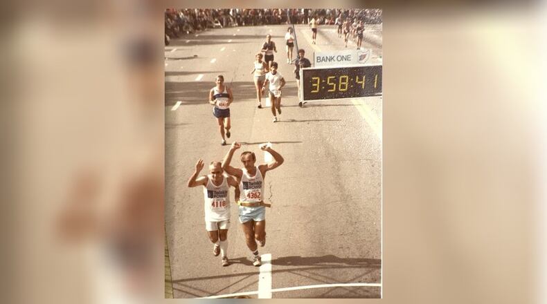 Larry Smith and Harry Bradbury raise their arms in triumph as they finish the 1983 Columbus Marathon in 3 hours and 48 minutes. “I had tears in my eyes,” Bradbury said. CONTRIBUTED PHOTO