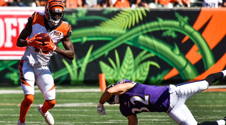 The Cincinnati Bengals wide receiver A.J. Green makes a catch as Baltimore safety Eric Weddle dives to grab him during their 20-0 loss to the Baltimore Ravens Sunday, Sept. 10 at Paul Brown Stadium in Cincinnati. NICK GRAHAM/STAFF