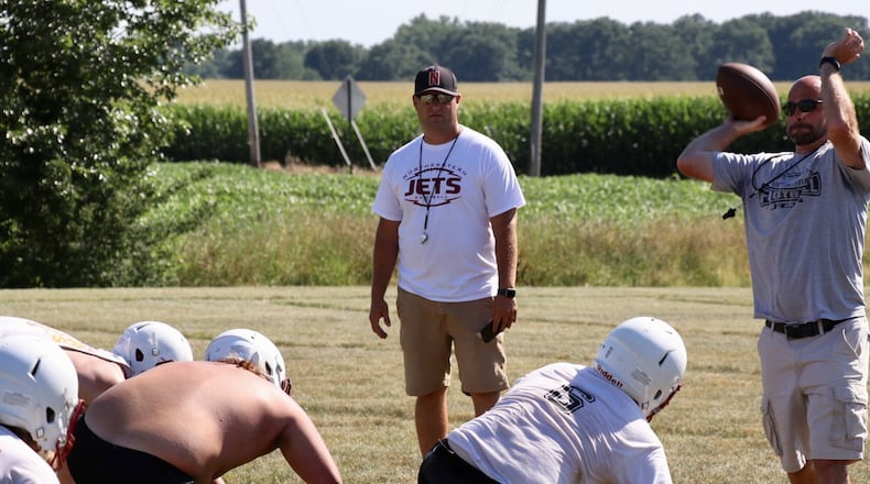 Jake Buchholtz (center) is the new football coach at Northeastern H.S. in 2018, succeeding Tim Houseman. CONTRIBUTED PHOTO