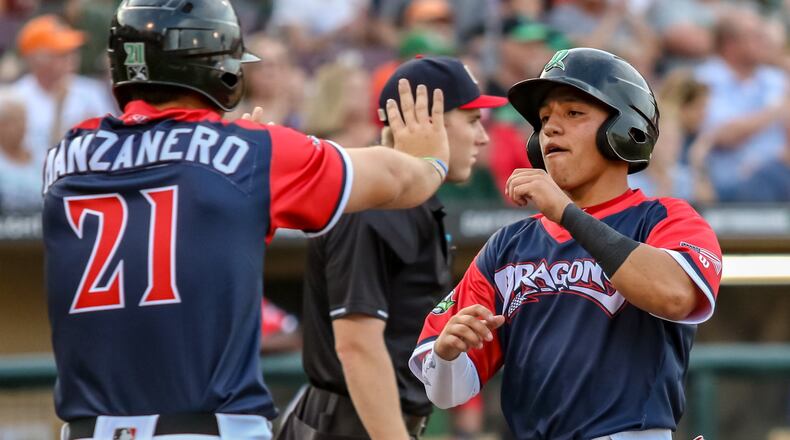 Dayton Dragons outfielder Brian Rey celebrates with Pabel Manzanero after both scored a run against the Bowling Green Hot Rods on Wednesday night at Fifth Third Field. The Dragons won 4-2. CONTRIBUTED PHOTO BY MICHAEL COOPER