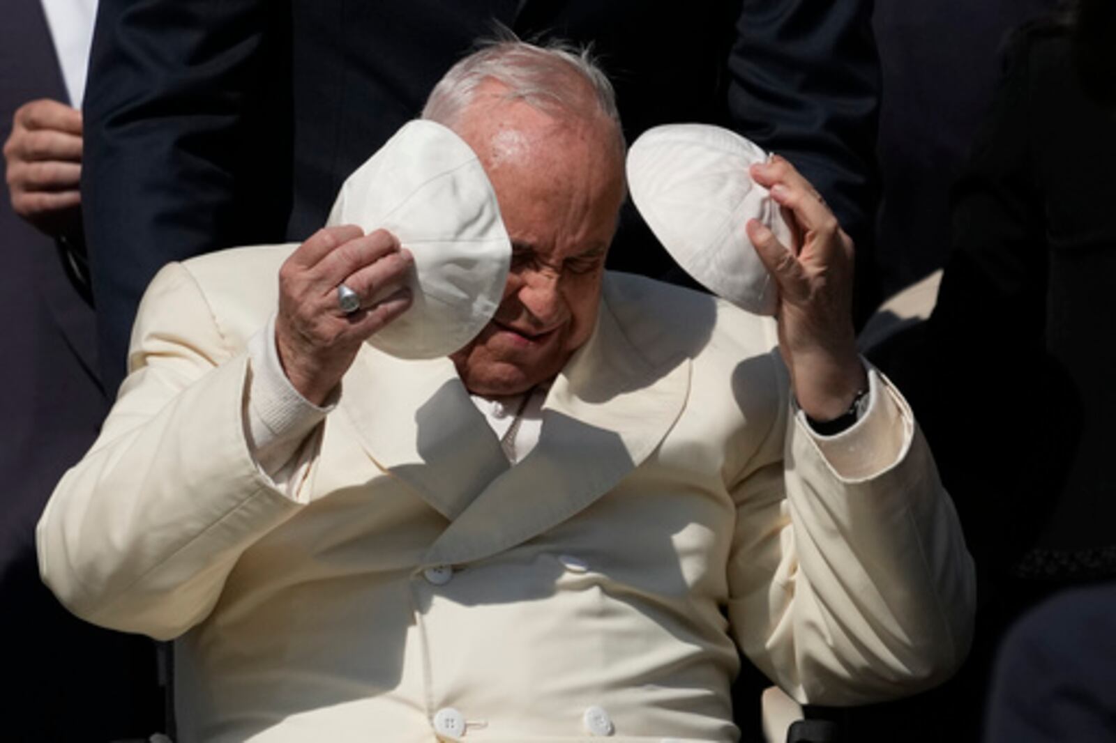 FILE - Pope Francis exchanges his skull cap with one presented by a participant in the weekly general audience in St. Peter's Square, at the Vatican, Wednesday, April 19, 2023. (AP Photo/Alessandra Tarantino, File)